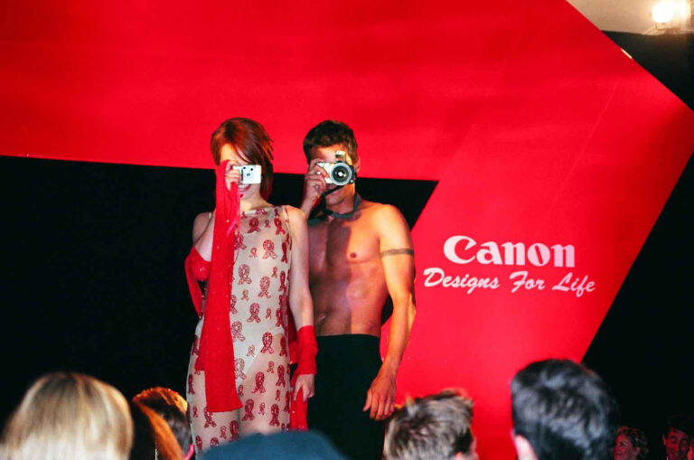 Models with cameras on catwalk at Canon Designs for Life AIDS red ribbon fashion show