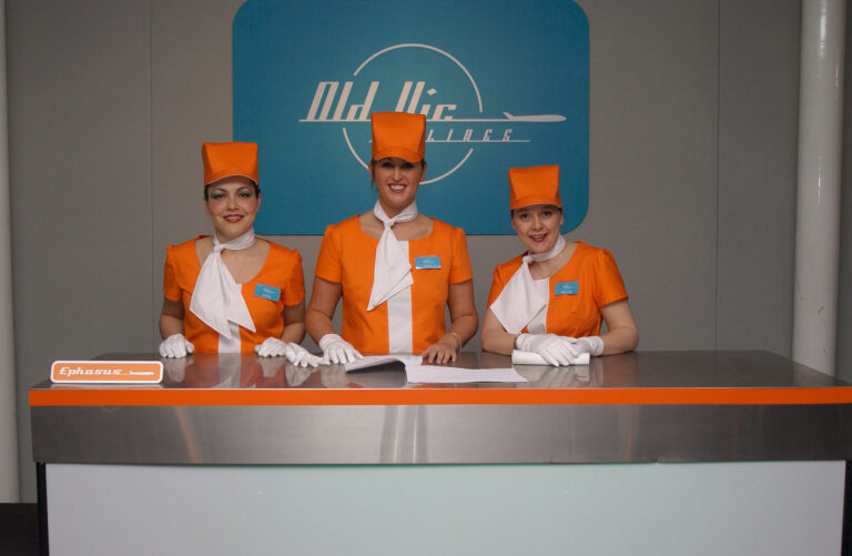 front desk staff dressed as retro air stewardesses at Kevin Spacey's fundraising party for The Old Vic theatre