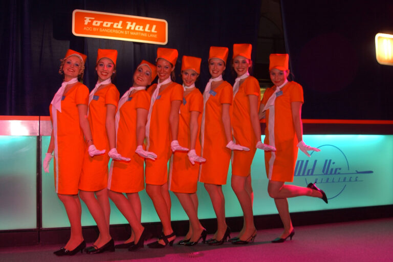 catering staff dressed as retro air stewardesses at Kevin Spacey's fundraising party for The Old Vic theatre